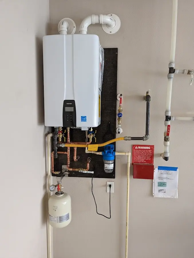 Professional plumber installing copper piping in a Thomaston home